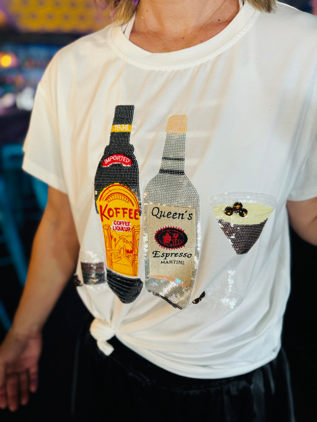 Close up of the Queen Of Sparkle Espresso Tee with sequins and rhinestones.