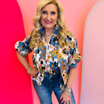 Floral half zip cotton top with puff sleeves, ribbed collar, and relaxed swingy fit.