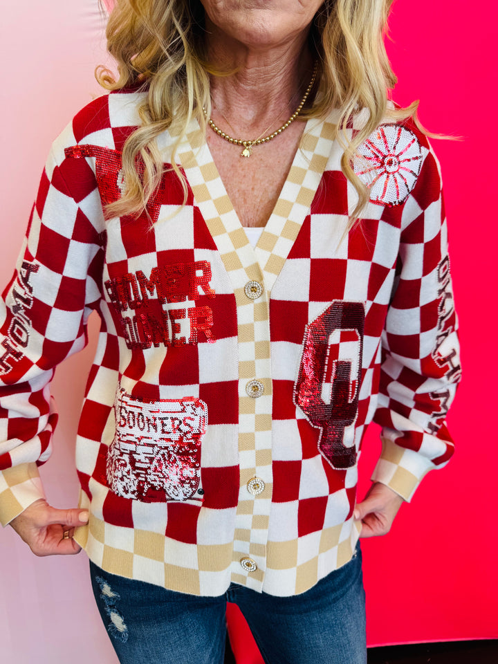 Close up of Queen of Sparkles checkered sequin and rhinestone game day cardigan.