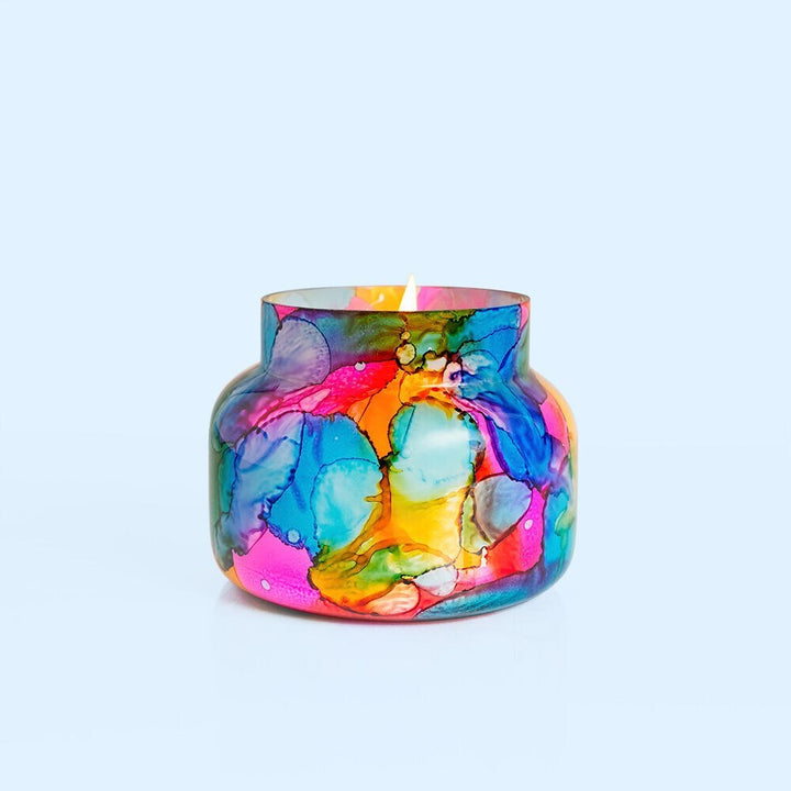 Rainbow watercolor glass jar candle with vibrant colors and a tropical fruit and citrus Volcano scent; decorative 19oz candle for home fragrance and style.