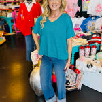 Lt. Teal boxy waffle knit top with V-neck, straight hem, split sides, and relaxed silhouette.