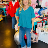 Lt. Teal boxy waffle knit top with V-neck, straight hem, split sides, and relaxed silhouette.