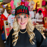 Black hat with “Holly Jolly” red and green embroidery and red-green-black-white plaid bill.