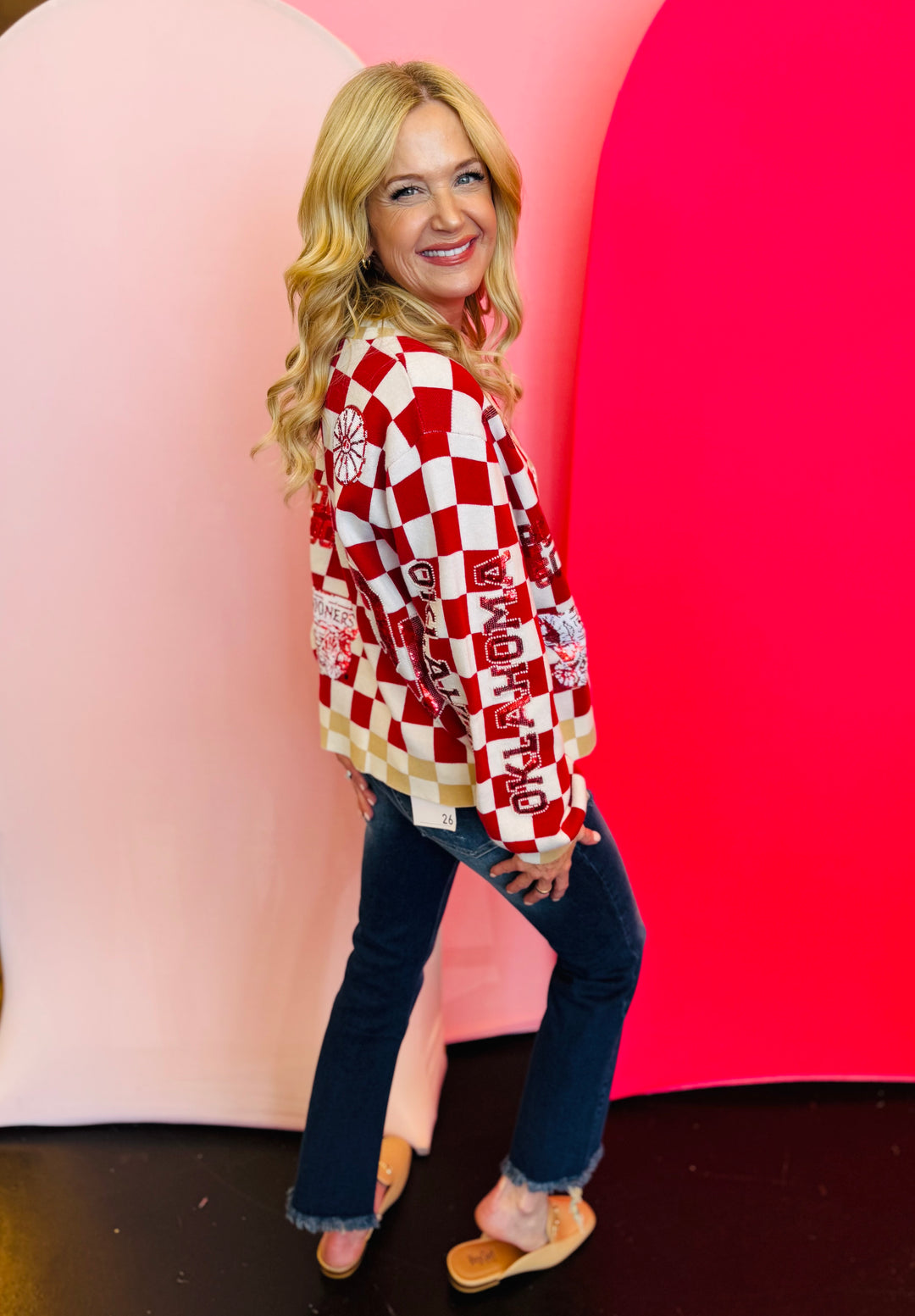 Side view of Queen of Sparkles checkered sequin and rhinestone game day cardigan.