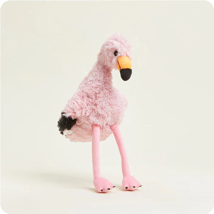 A soft, pink plush flamingo toy with long legs and a curved beak, designed to be microwavable.