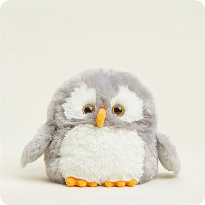 A soft, plush owl toy with large, friendly eyes and textured fabric on its wings, designed to be microwavable.