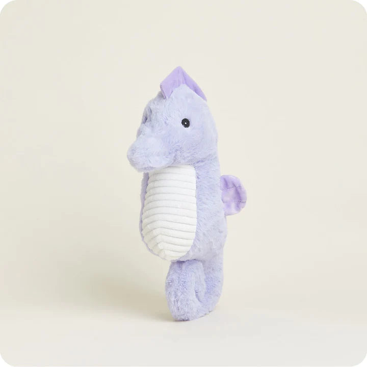 A soft, plush seahorse toy with a curled tail and fins, designed to be microwavable.