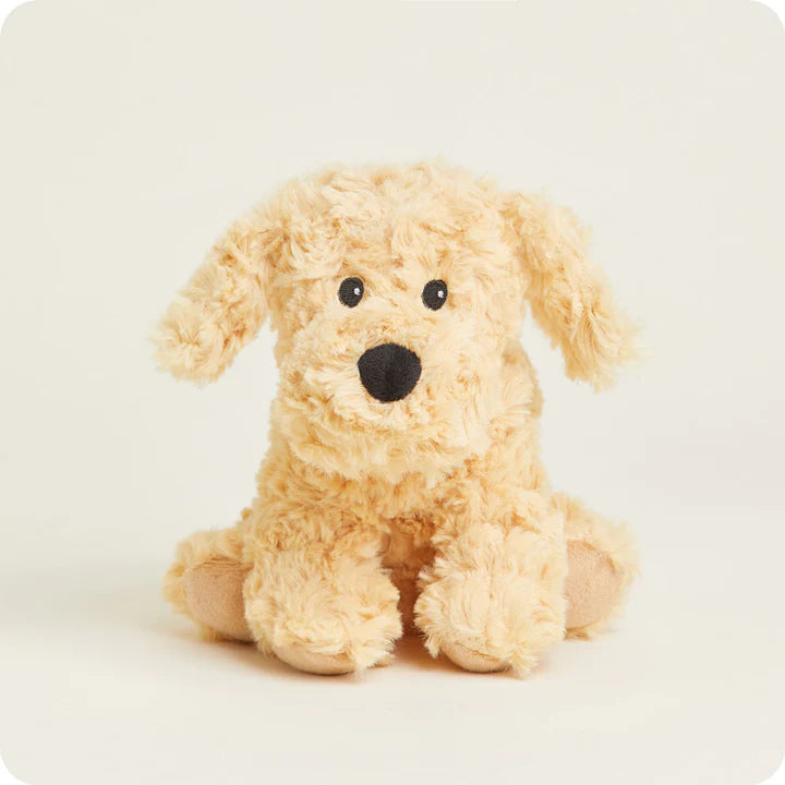 A small, soft plush golden retriever puppy toy, designed to be microwavable. It has floppy ears and a friendly expression.