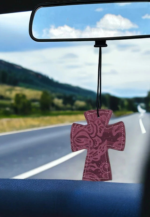 Cross-shaped hair-on-hide and leather car freshener charm, stitched design.