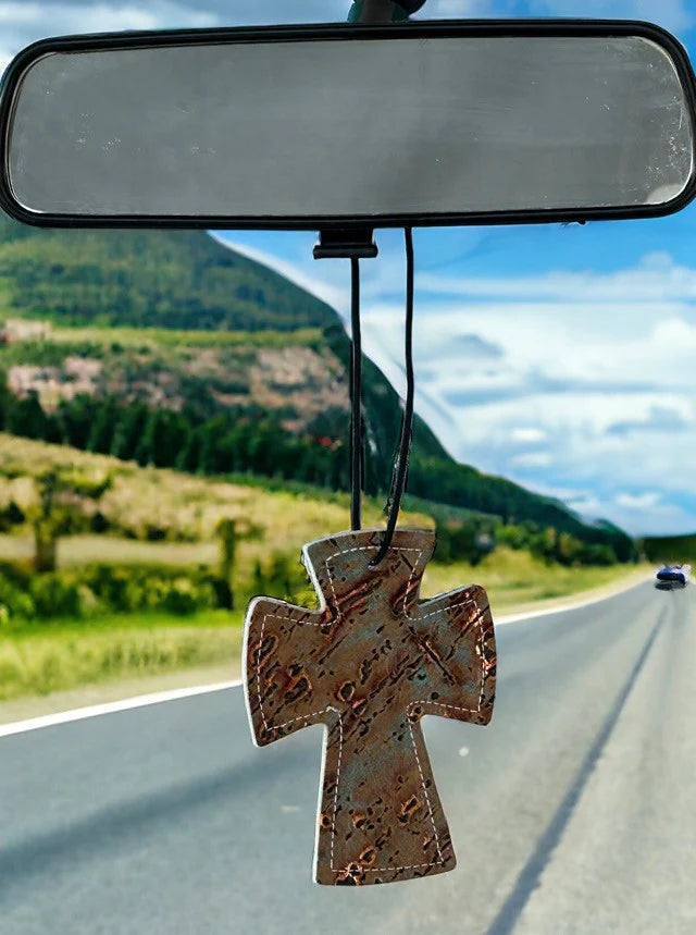 Cross-shaped hair-on-hide and leather car freshener charm, stitched design.