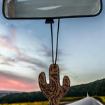 Cactus-shaped leather and hair-on-hide reusable car freshener charm designed for re-scenting with oils.