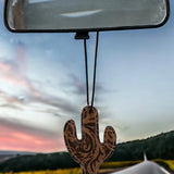 Cactus-shaped leather and hair-on-hide reusable car freshener charm designed for re-scenting with oils.