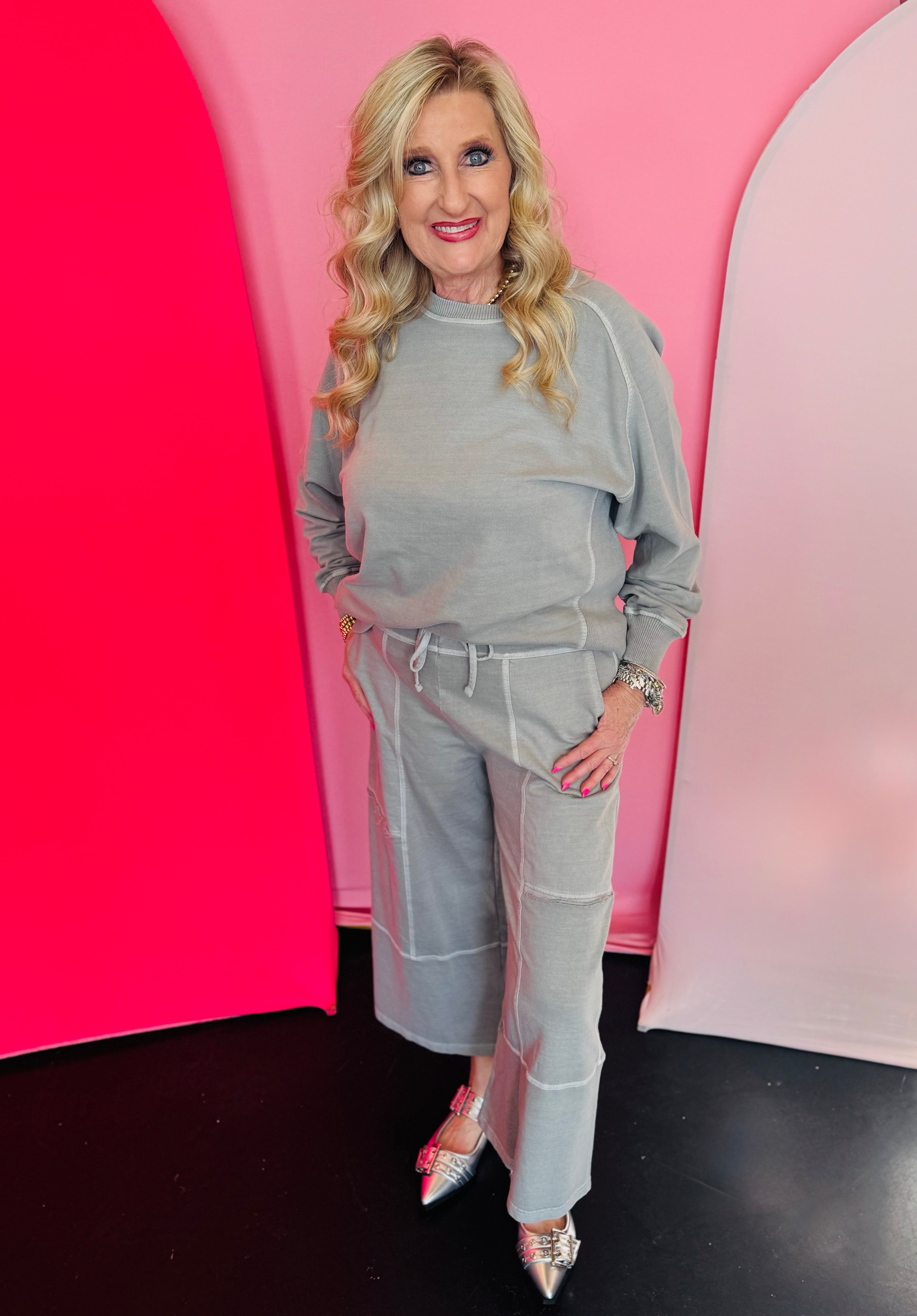 Sleet-colored wide-leg cotton French terry pants with drawstring waistband, contrast seams, cropped raw-edge hem.