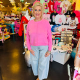 Candy pink brushed hacci sweater with exposed seams and relaxed fit shown from the front.