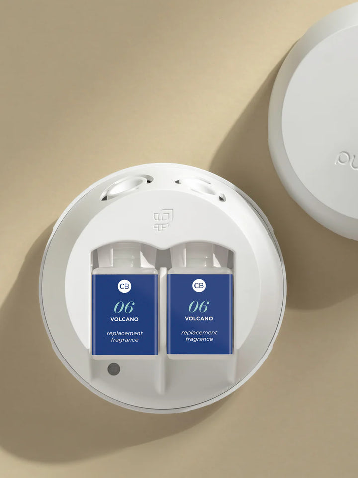 Pura Volcano fragrance refill set with clean, tropical citrus and vanilla scent notes; long-lasting and app-controlled smart home fragrance system.