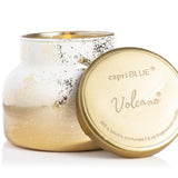 Capri Blue Volcano Glimmer Petite Candle with winter white and gold finish and tropical citrus fragrance.