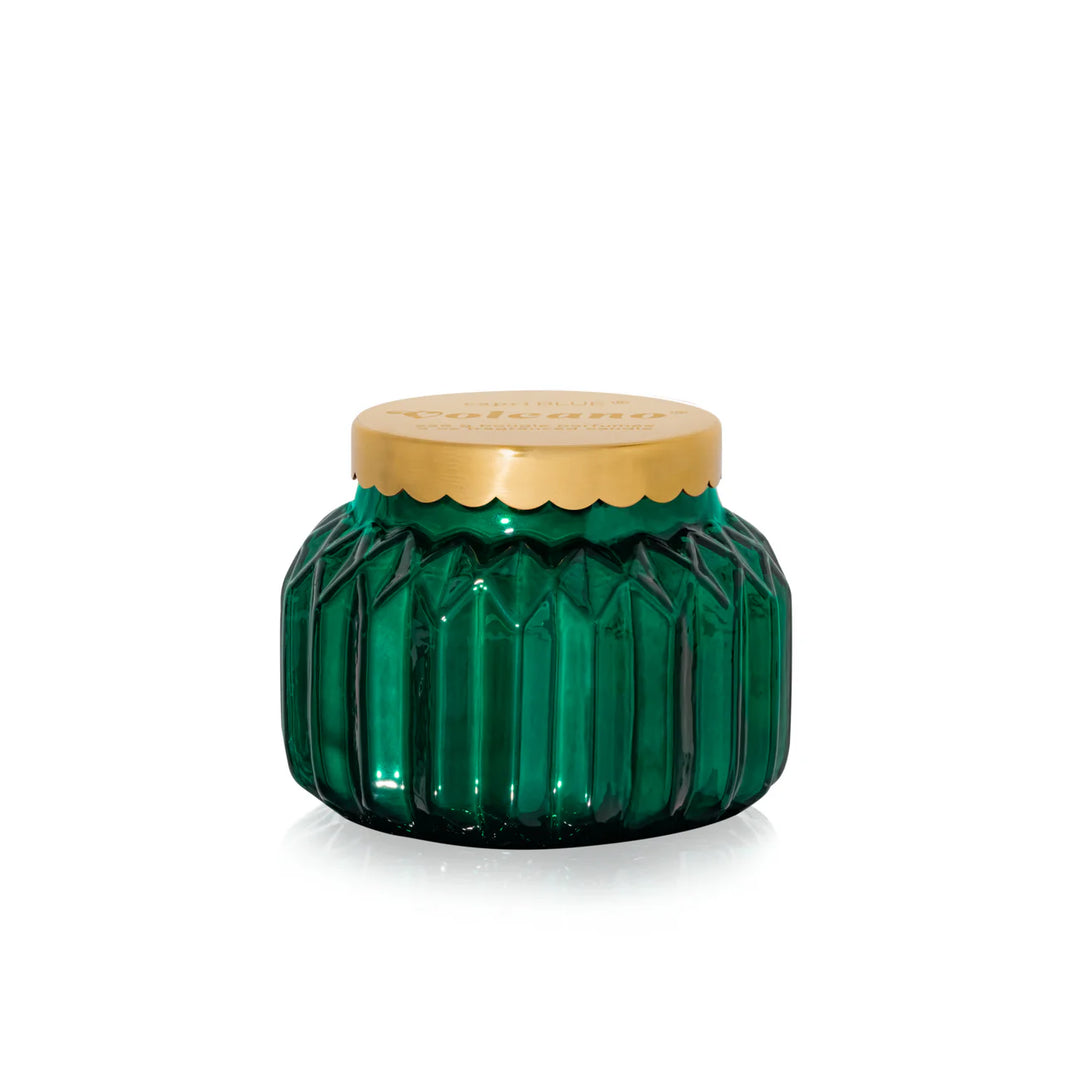 An 8oz Capri Blue Volcano Royal Gem Petite Candle in a decorative green jar.
