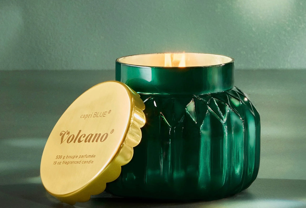 Capri Blue - 19oz Volcano Royal Gem Signature Candle in a faceted emerald green jar with a gold lid.