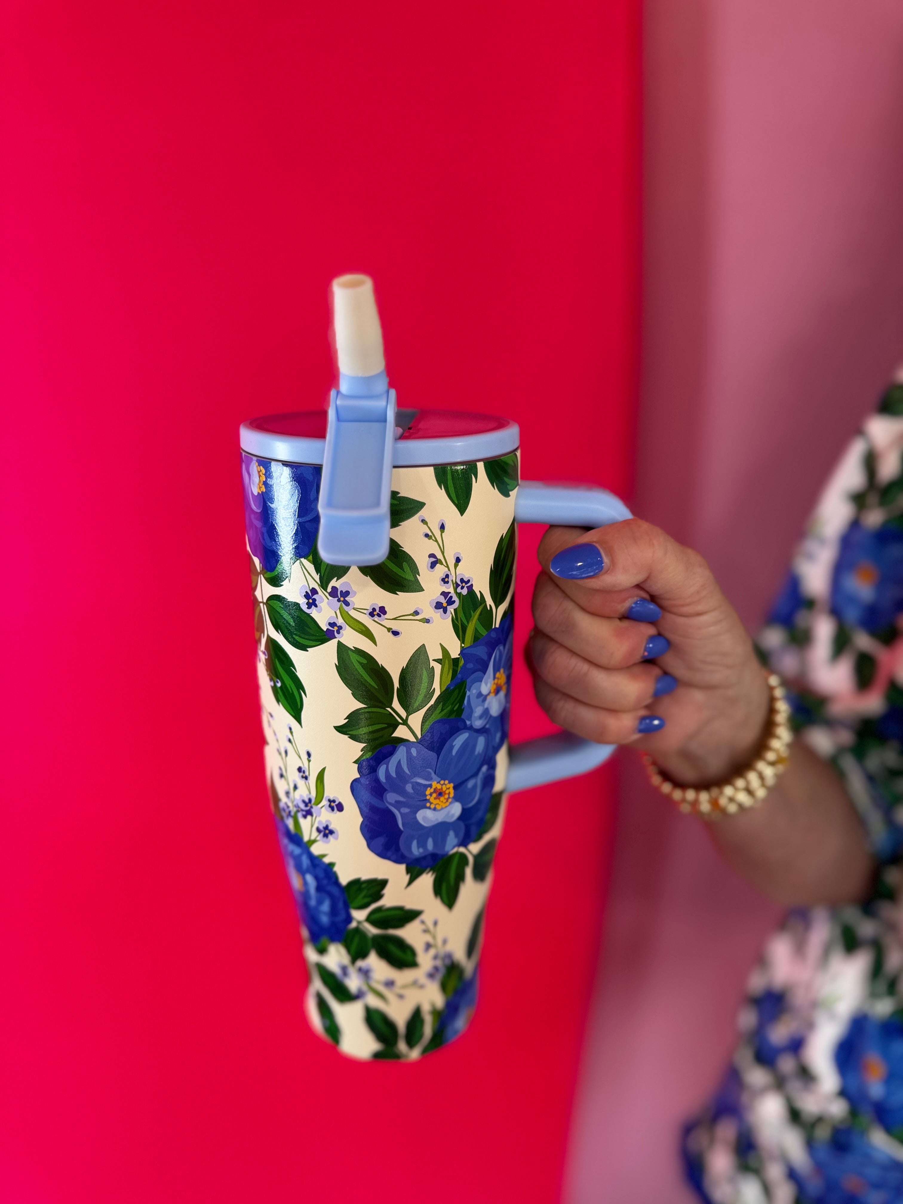 40 oz tumbler with blue floral print, handle, and flip straw lid.