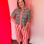 Leopard blouse with red striped trim and tie sleeves.
