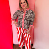 Leopard blouse with red striped trim and tie sleeves.