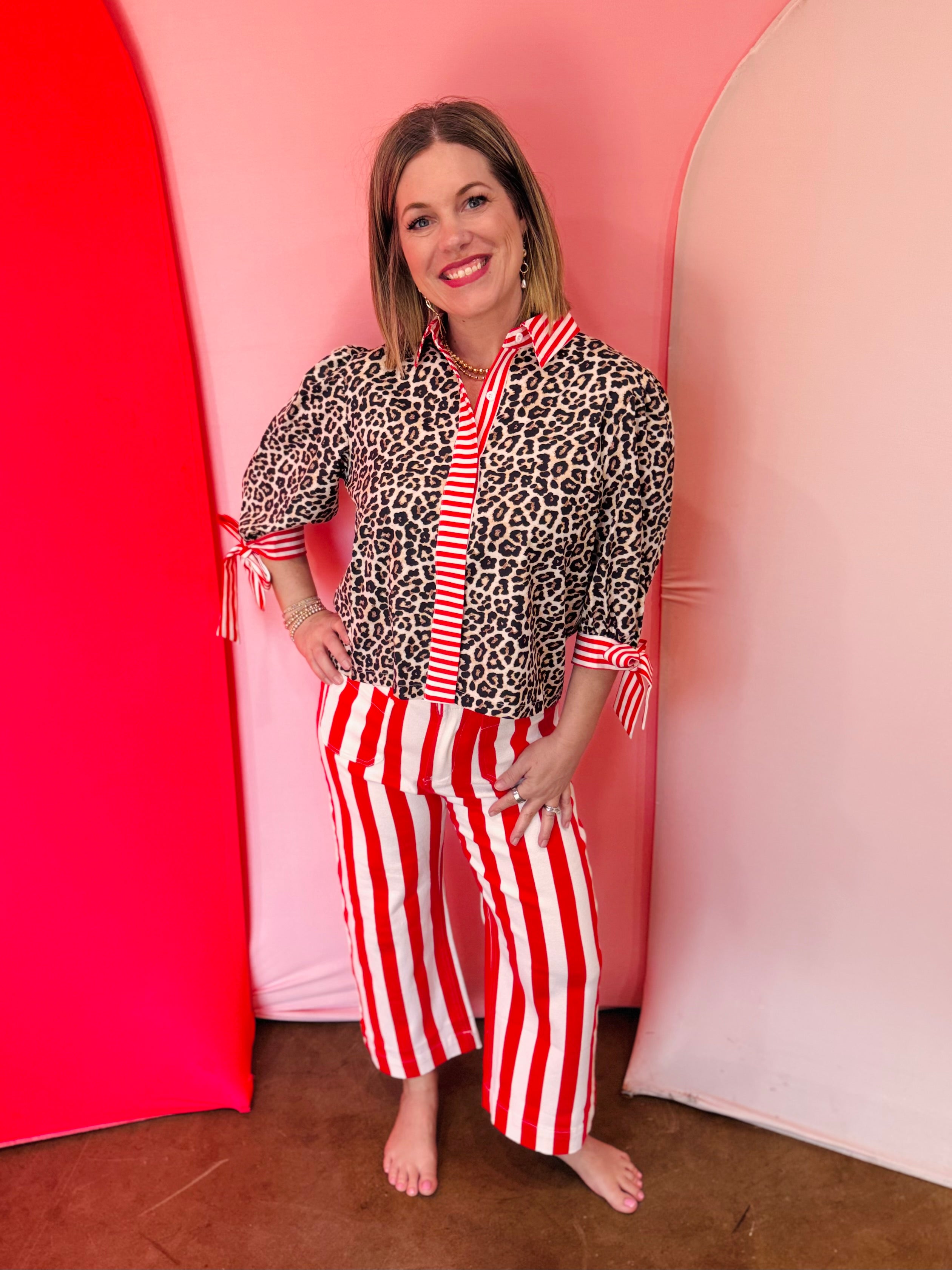 Leopard blouse with red striped trim and tie sleeves.
