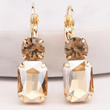 Champagne rhinestone earrings with matching stud and gold settings.