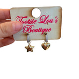 Silver hoop earrings with gold heart and star charms, sparkling stones, playful two-tone design