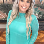 Turquoise checkered mesh top with rhinestone sleeves, lightweight stretchy fabric, perfect for bold trendy outfits.