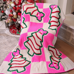Pink checkered blanket with Christmas treats and pink bow design.