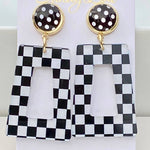 Black and white checkered acrylic dangle earrings with black polka dot stud.