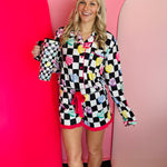 Checkered pajama set with conversation hearts, pink piping, and ruffled shorts with bow trim.