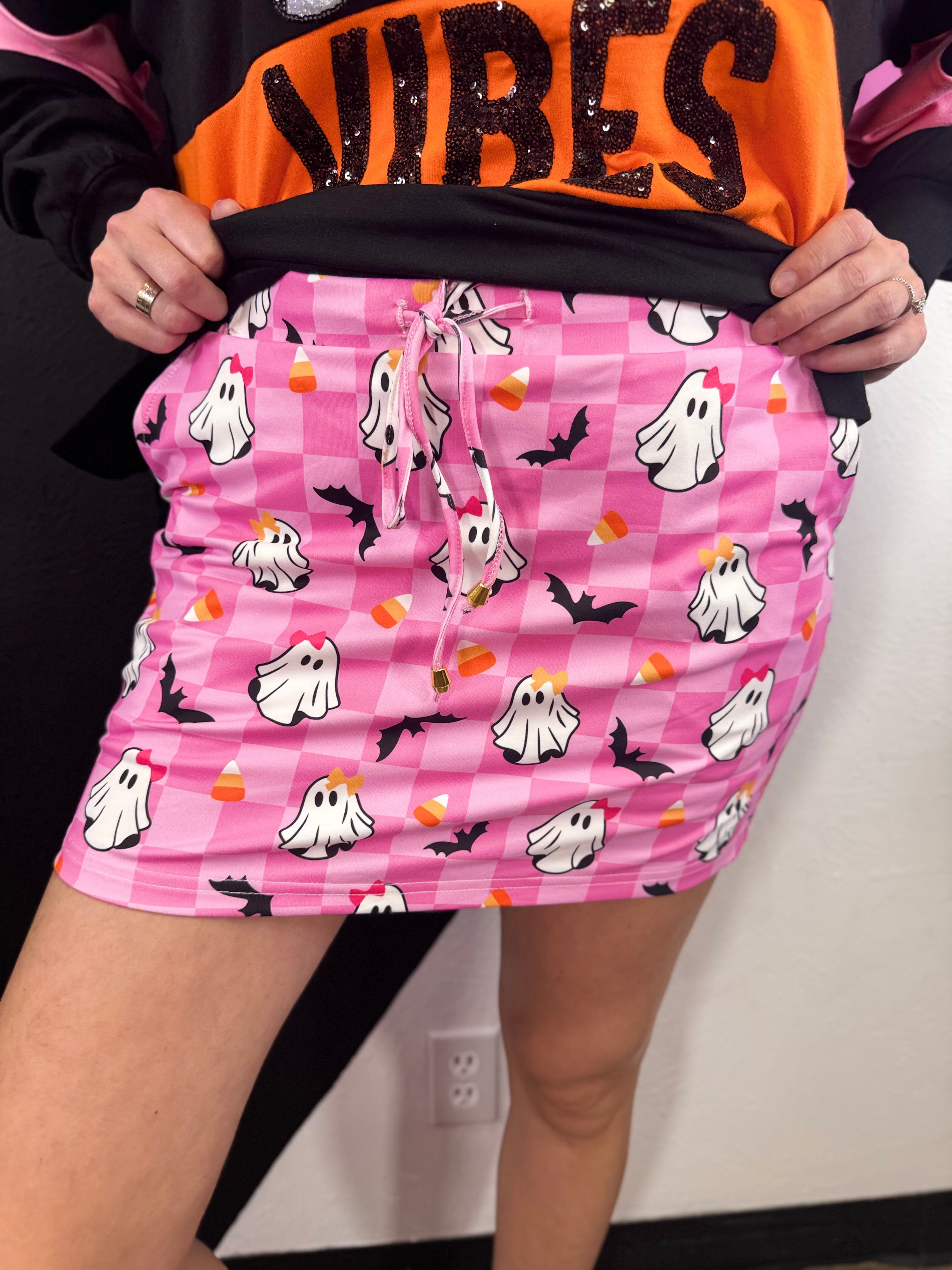 Pink checkered Halloween skort with ghosts, bats, candy corn and built-in shorts.