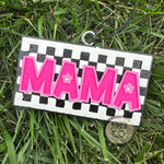 Checkered pink and black mama car freshie with hook and string hanging in car.