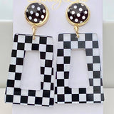 Black and white checkered acrylic dangle earrings with black polka dot stud.