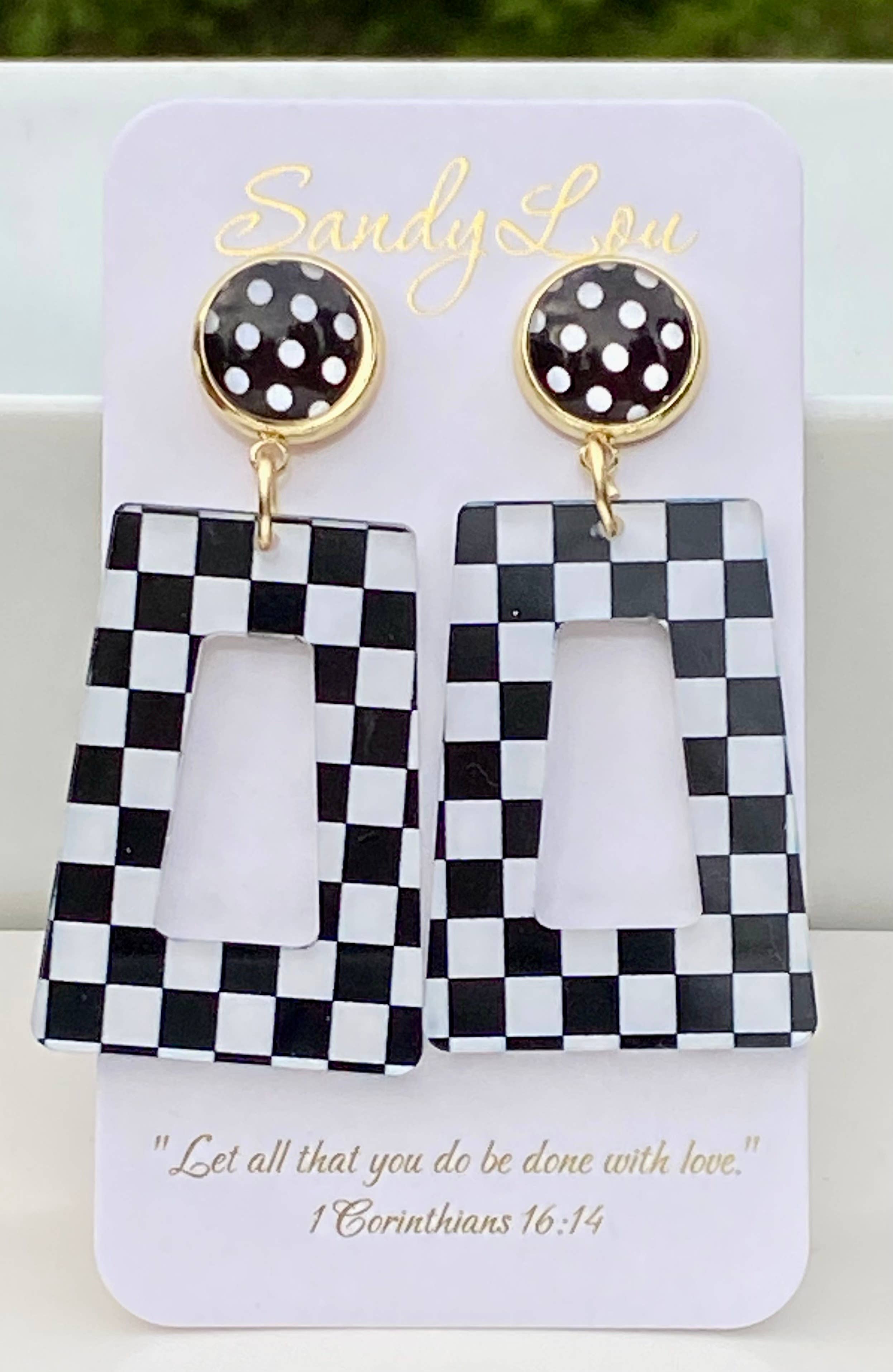 Black and white checkered acrylic dangle earrings with black polka dot stud.