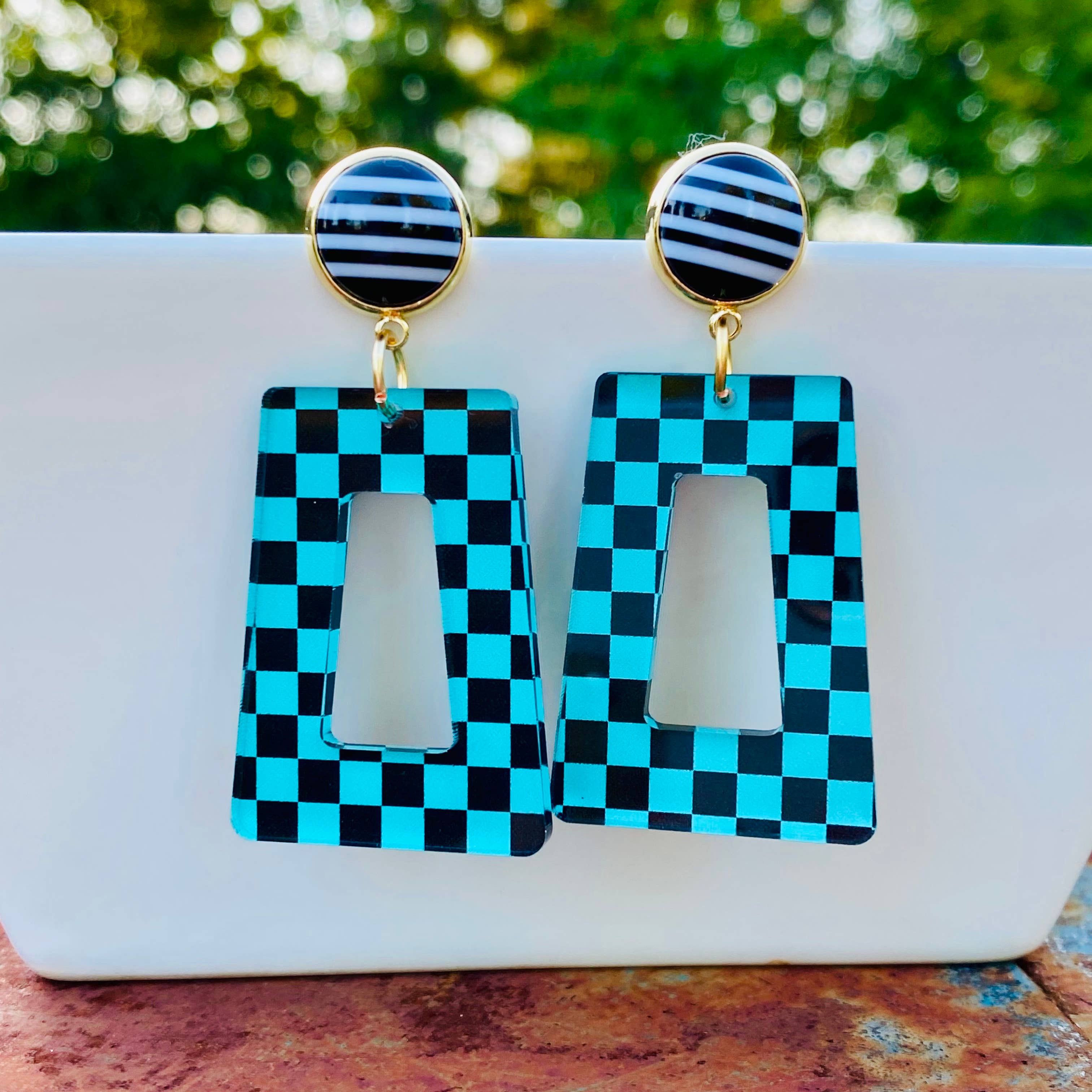 Teal and black checkered acrylic dangle earrings with black polka dot stud.