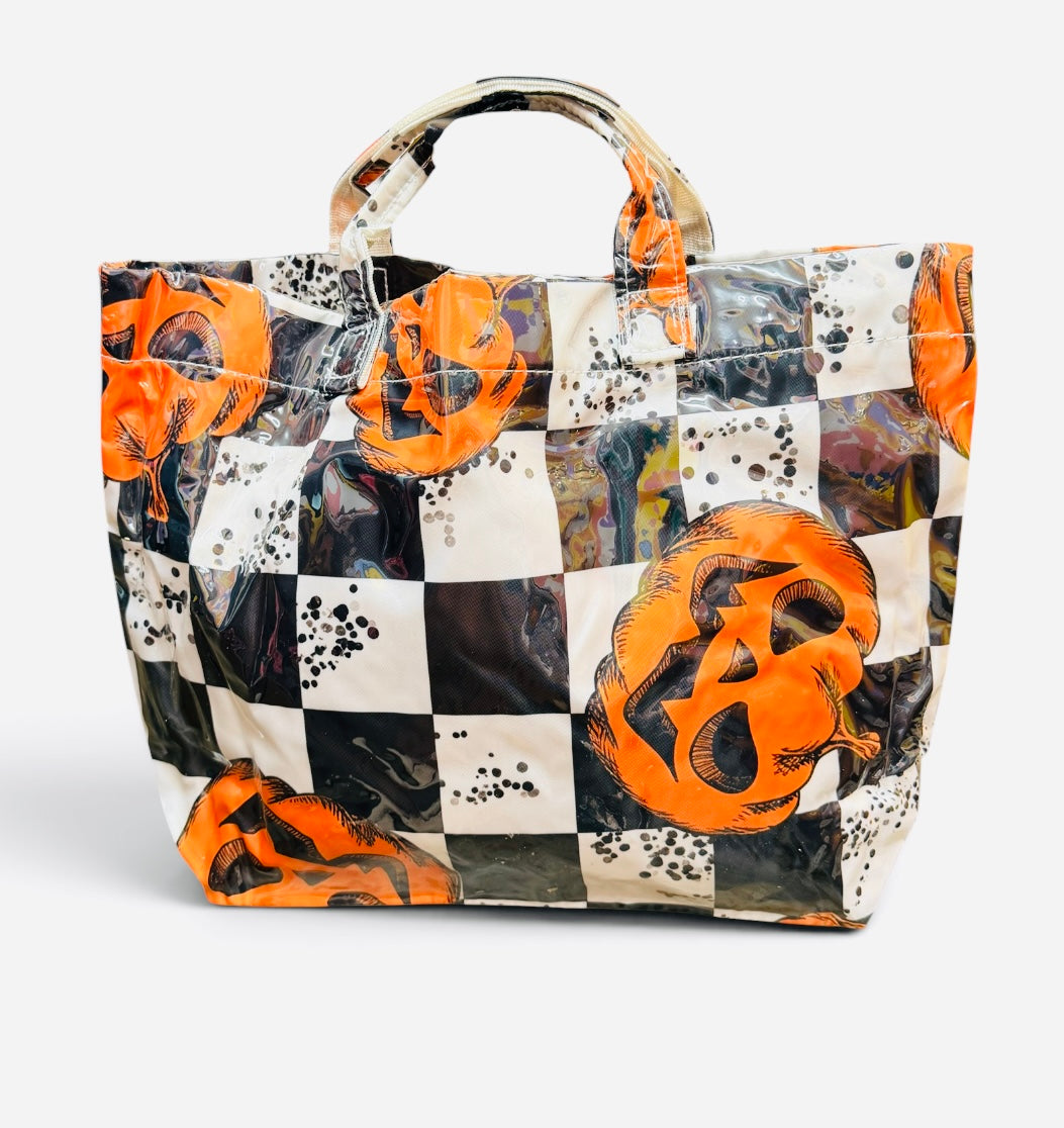 Halloween tote with orange jack-o'-lanterns, black and white checkerboard print, and splatter accents.
