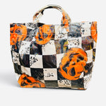 Halloween tote with orange jack-o'-lanterns, black and white checkerboard print, and splatter accents.