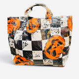 Halloween tote with orange jack-o'-lanterns, black and white checkerboard print, and splatter accents.