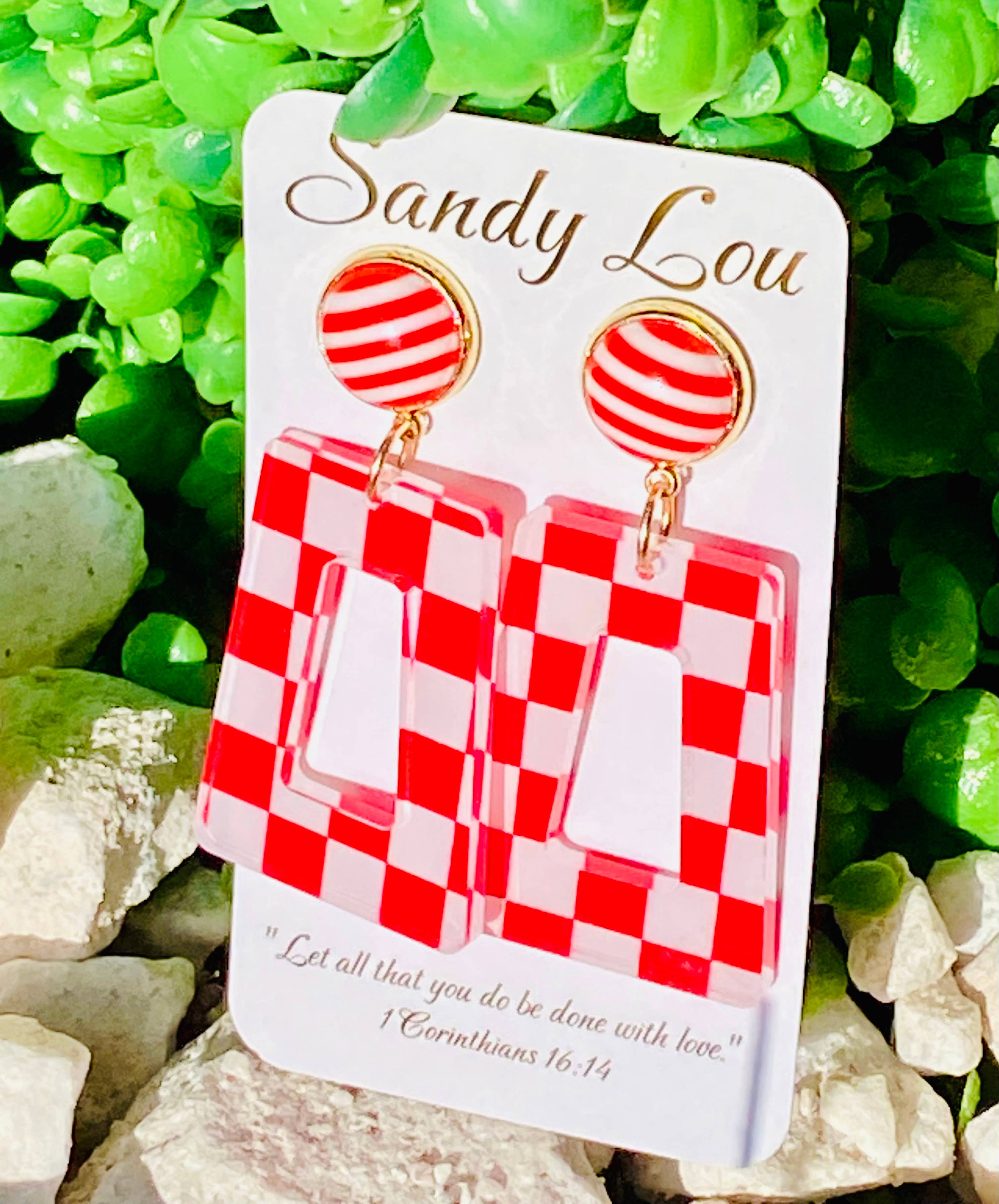Red and white checkered acrylic earrings with striped stud tops.