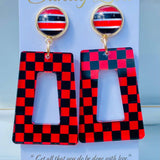 Red and black checkered acrylic dangle earrings with coordinating striped studs.