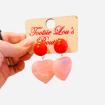 Red stud earrings with blush pink oversized heart drop.