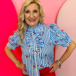 Blue and white striped cherry print blouse with ruffle neckline, puff sleeves, and button front design