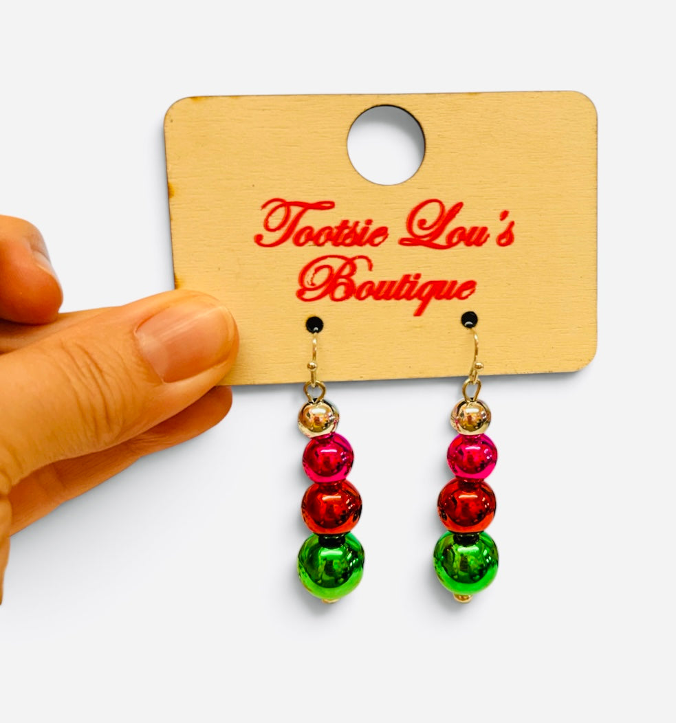 Pink, red, and green Christmas ornament bead drop earrings with gold-tone accents.