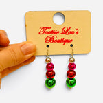 Pink, red, and green Christmas ornament bead drop earrings with gold-tone accents.