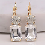 Clear rectangle rhinestone earrings with round rhinestone top and fish hook dangle.