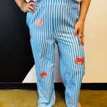 Blue striped pants with seashell, crab, and coastal-inspired print details.