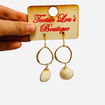 Gold hoop earrings with ivory clam shell charms and fishhook backs beach inspired design