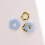Matte light blue daisy hoop earrings with removable flowers and gold hoop.
